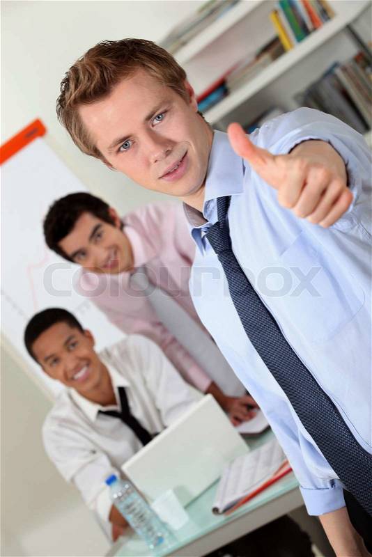 Young businessmen giving the go-ahead, stock photo
