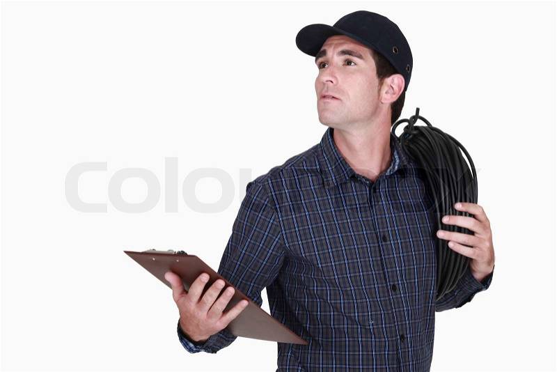 Electrician carrying extension lead, stock photo