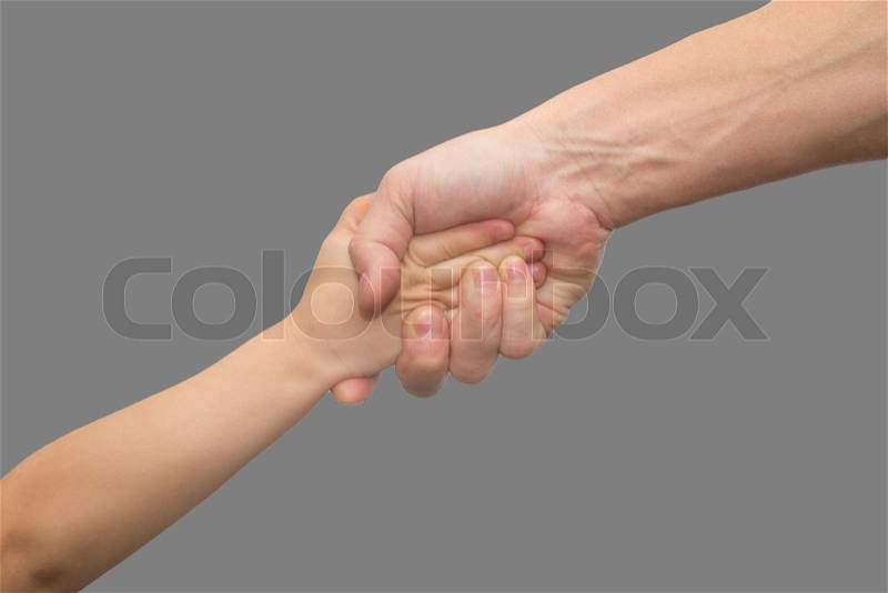 Hands of father and son on a gray background, stock photo