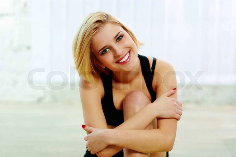 Portrait of a young fit cheerful woman smiling on camera, stock photo