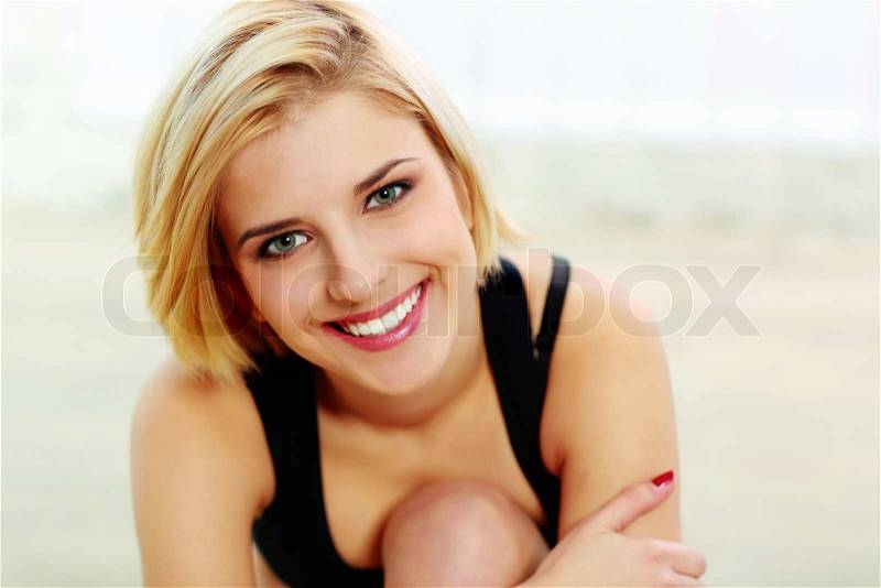 Portrait of a young fit woman smiling on camera, stock photo