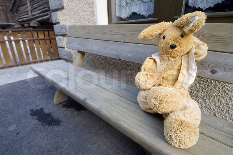 Stuffed animal sitting on a bench in the village of Zermatt, Alps, Switzerland, stock photo