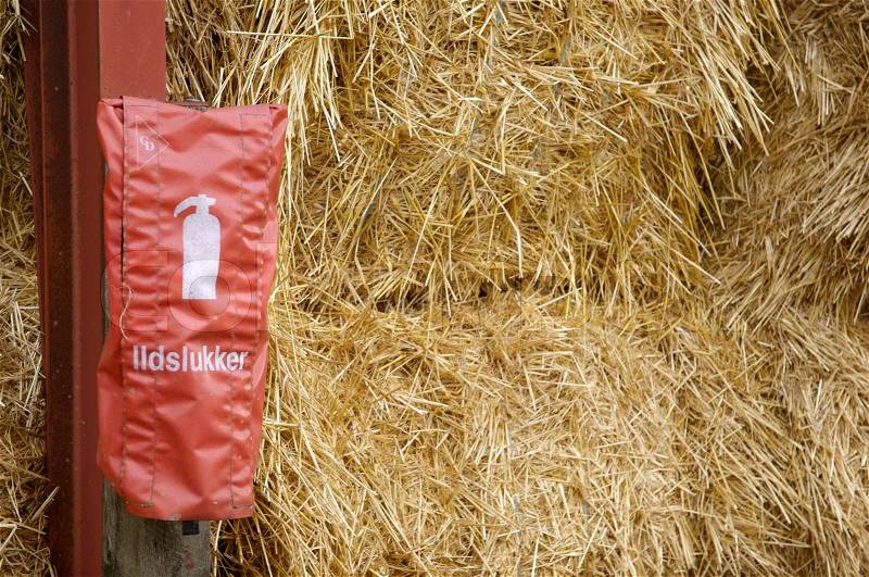 Close-up on fire extinguisher hanging in a farm, stock photo