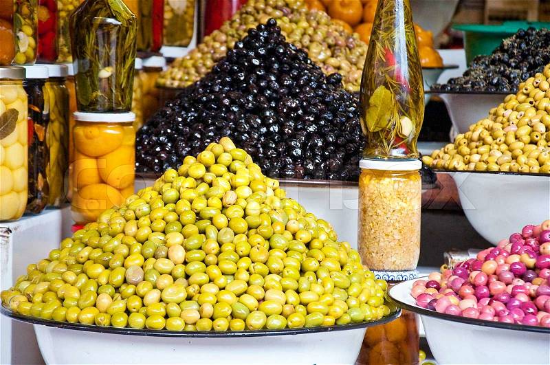 It is a lot of multi-colored olives and olive oil in the market, stock photo