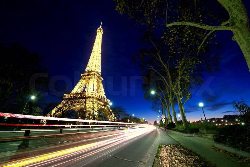 PARIS - DEC 1: Eiffel Tower shows its wonderful lights at sunset with car light trails, December 1, 2012 in Paris. The Tower is lit by more than 350 lamps mounted within the structure of the tower itself, stock photo
