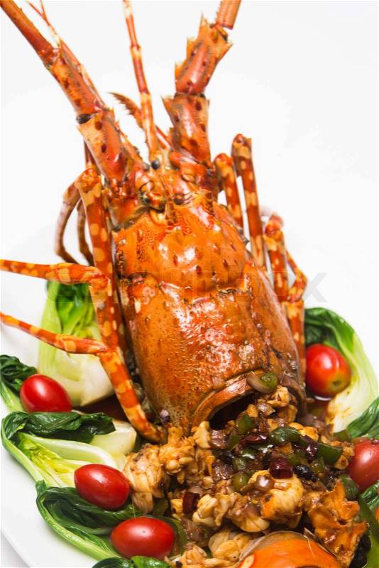 A luxury dish of lobster roasted and decorated with many items of vegetable, stock photo