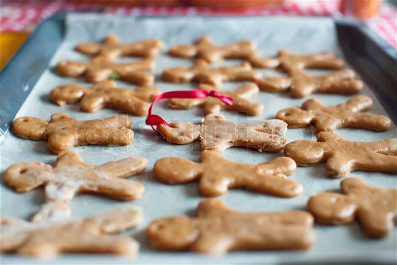 Raw gingerbread men on a baking, stock photo
