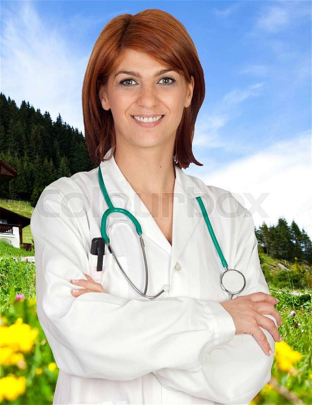 Attractive doctor with a nice landscape background, stock photo