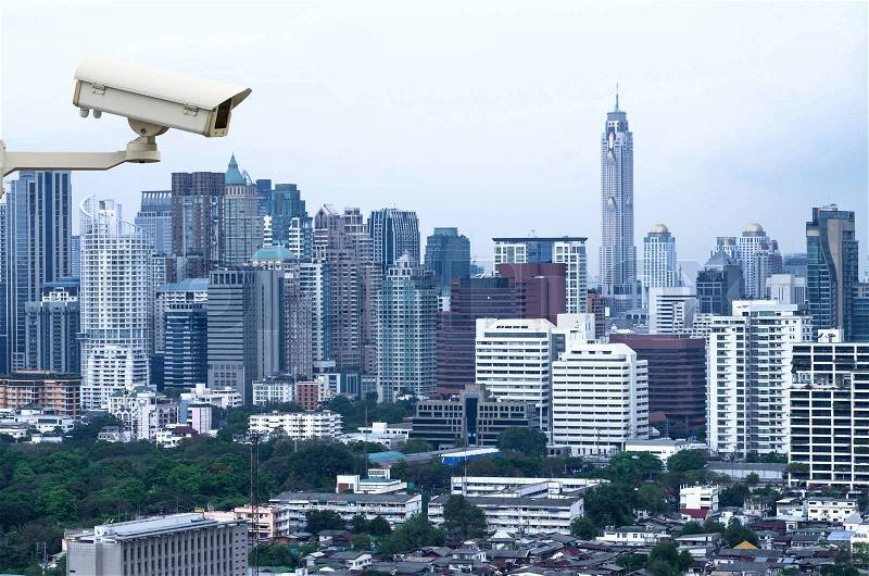 Security camera monitoring the traffic movement on top view of cityscape. Skyscraper rooftop, stock photo