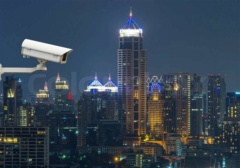 Security camera monitoring the traffic movement on top view of cityscape. Skyscraper rooftop, stock photo