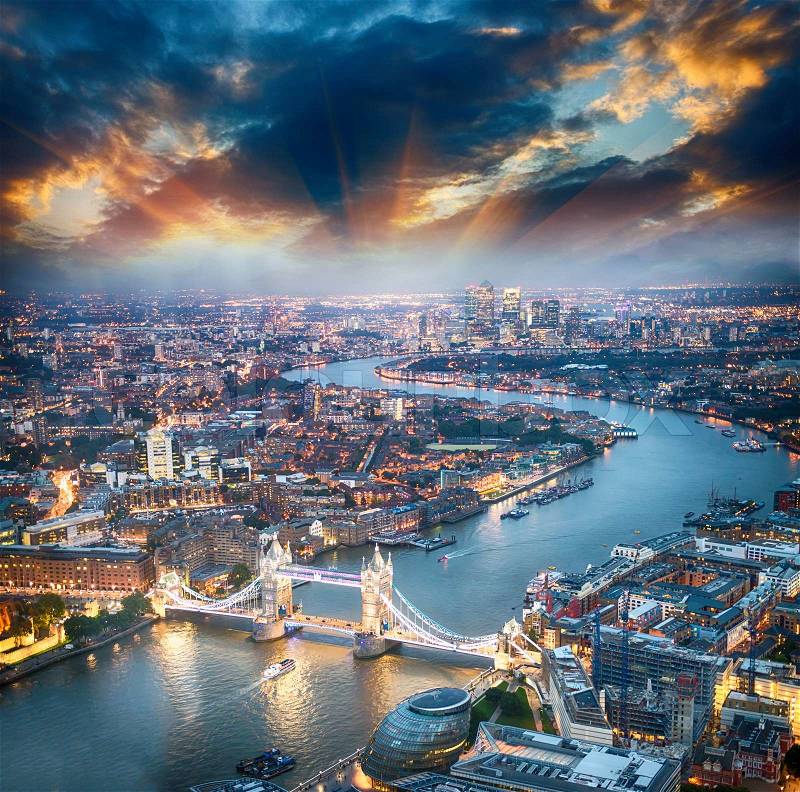 London. Aerial view of Tower Bridge at dusk with beautiful city skyline, stock photo