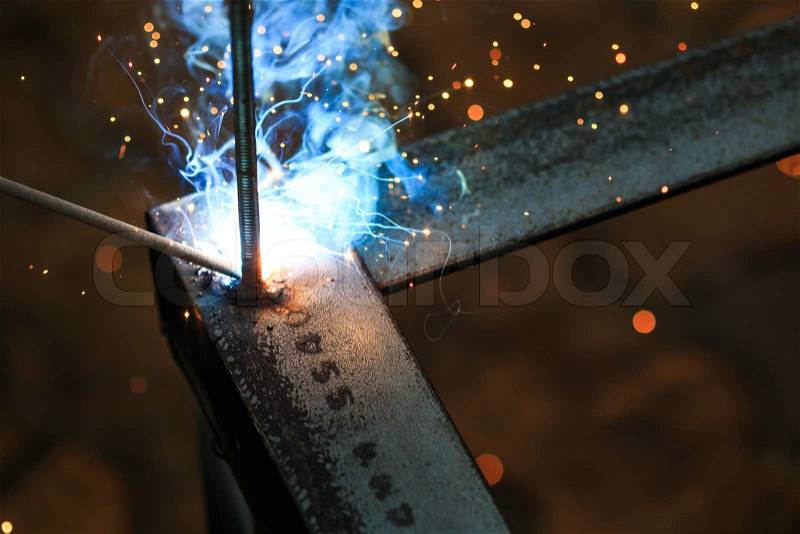 Worker with welding metal and sparks welding with sparks, stock photo