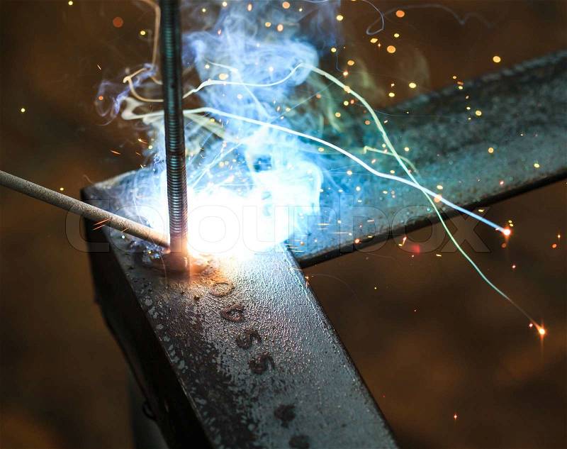 Worker with welding metal and sparks welding with sparks, stock photo
