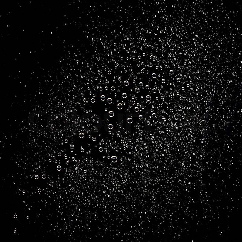 Water drops on black surface, stock photo