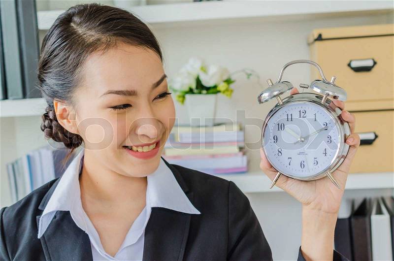 Young business women with clock, stock photo
