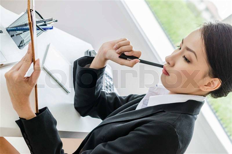 Business women thinking in office, stock photo