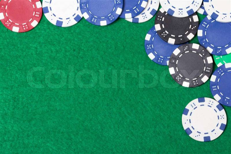 Poker chips on a green casino table background, stock photo