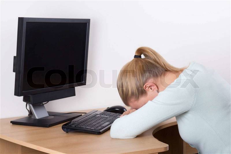 Stressed woman with personal computer at work in office, stock photo