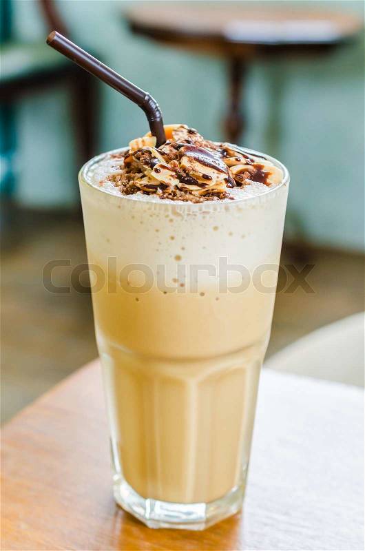 Coffee frappe with almond on top in coffee shop, stock photo