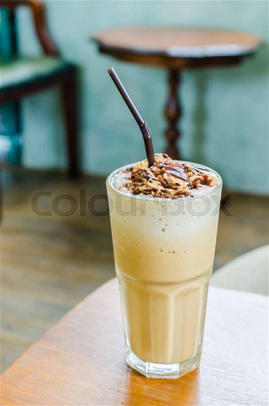 Coffee frappe with almond on top in coffee shop, stock photo