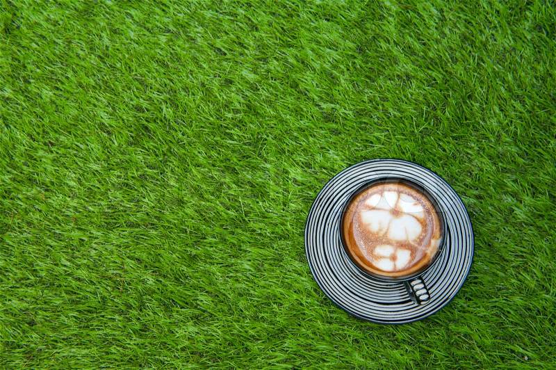 Coffee put on grass field, stock photo