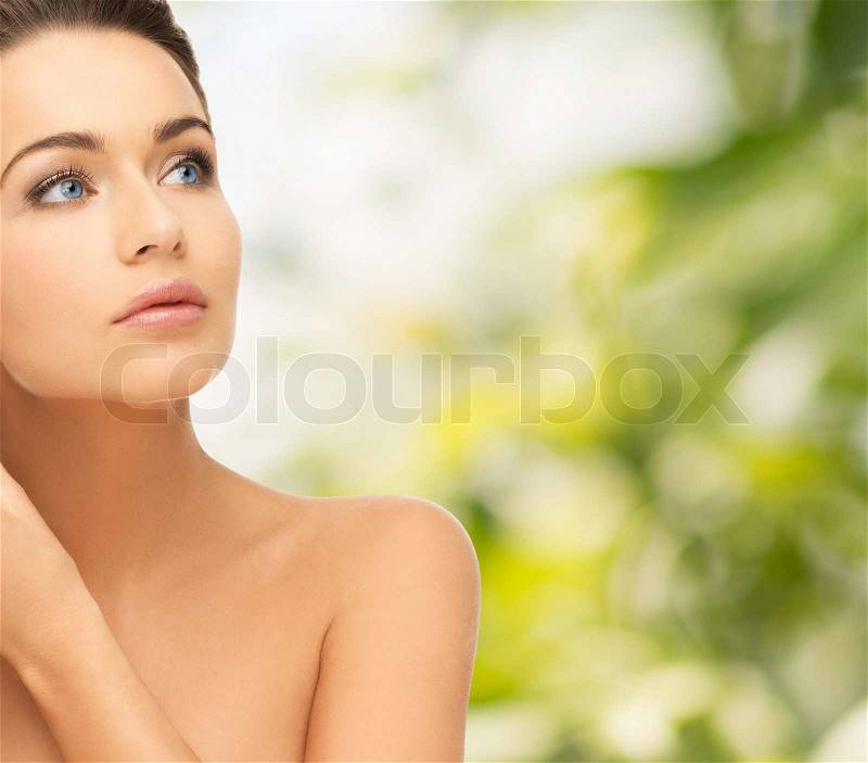 Beauty and health concept - beautiful woman looking up, stock photo