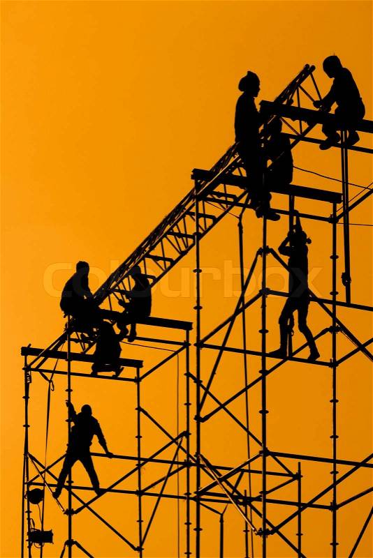 Silhouette of Workmen on assembling concert stage, stock photo