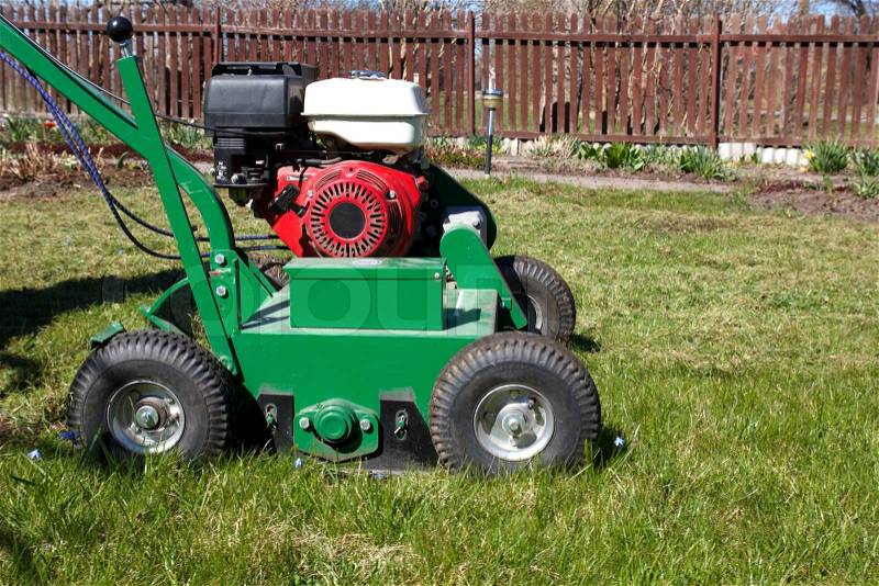 Lawn Aerator.A lawn aerator is a garden tool or machine designed to aerate the soil in which lawn grasses grow, stock photo