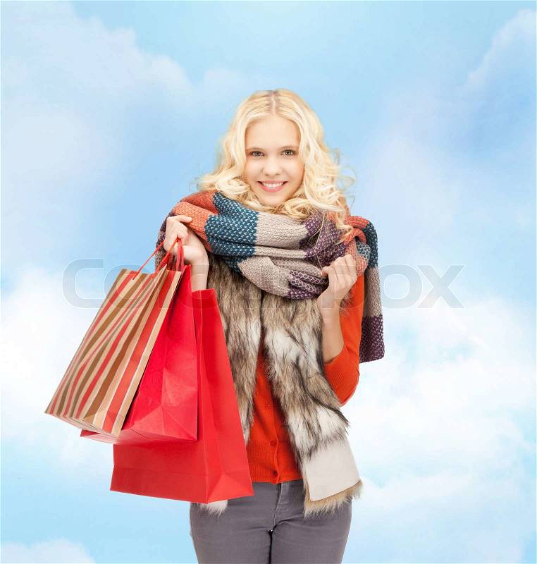 Sale and shopping concept - lovely teenage girl with shopping bags, stock photo