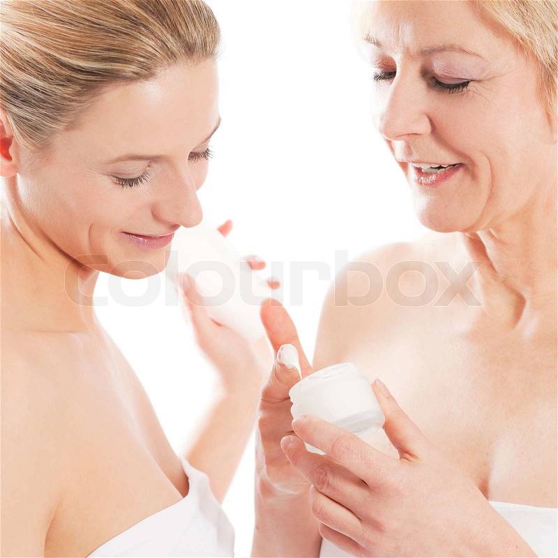 Beauty and skin care - mother and daughter with cream, stock photo