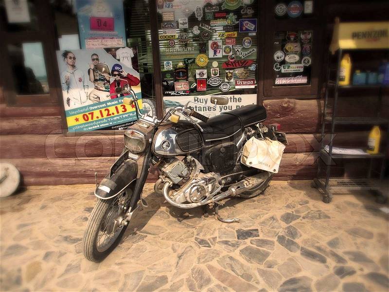Old motorbike on vintage style background, stock photo