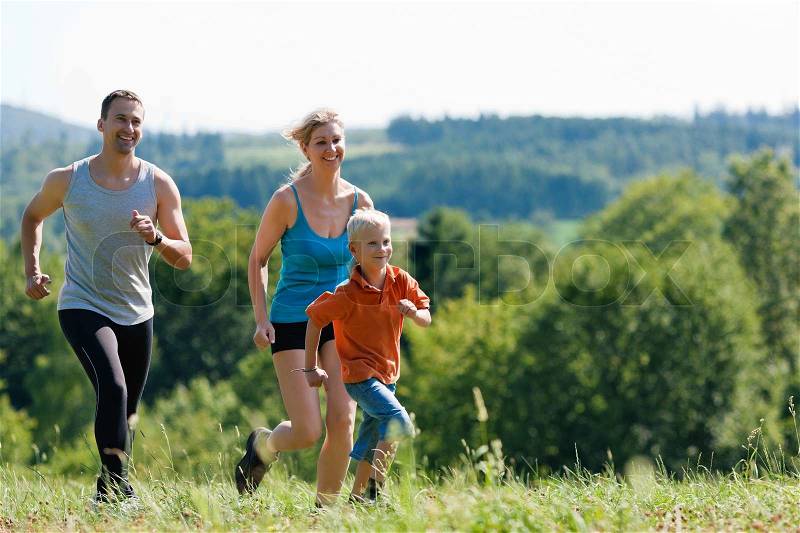 Active Family jogging outdoors in beautiful summer landscape  , stock photo