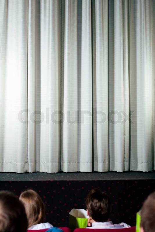 People in the cinema waiting for the movie to start, stock photo