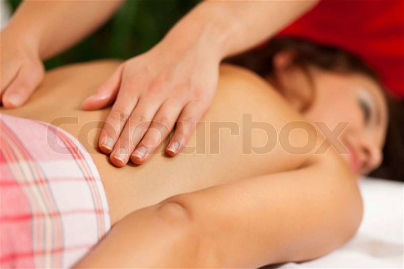 Wellness - woman getting massage in Spa; it is a traditional back massage, stock photo