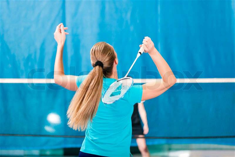 Women playing Badminton and doing sport in gym, stock photo