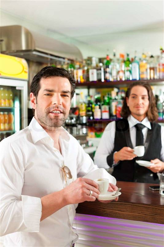 Coffeeshop - barista in cafe with a client, he is drinking coffee, the waiter too, stock photo