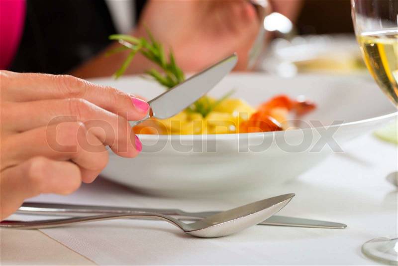 People fine dining food at table in hotel or elegant restaurant, stock photo