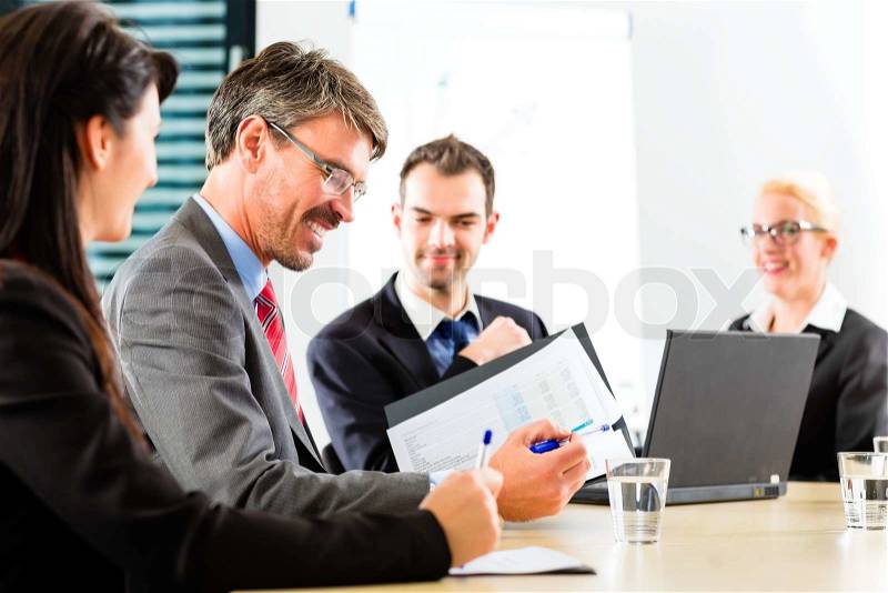 Business - businesspeople have a meeting with presentation in office, they negotiate a contract, stock photo