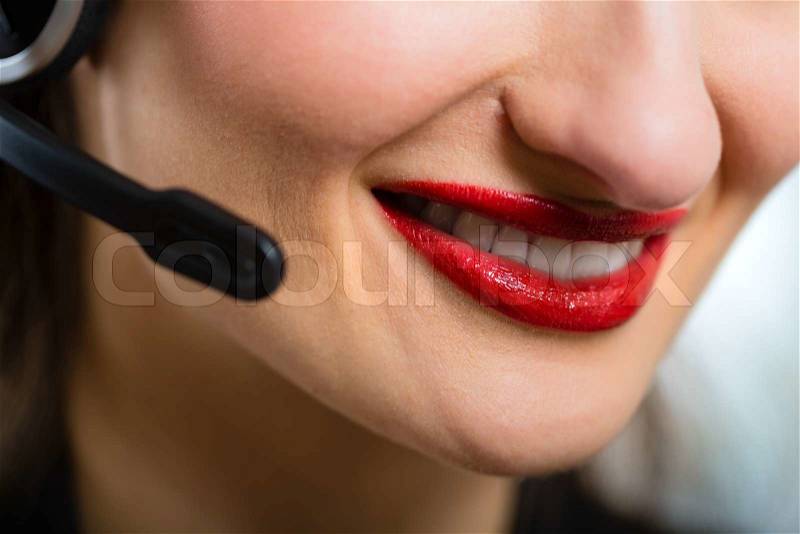 Young businesswoman or secretary working in her Office with a headset, she has a customer pitch, stock photo