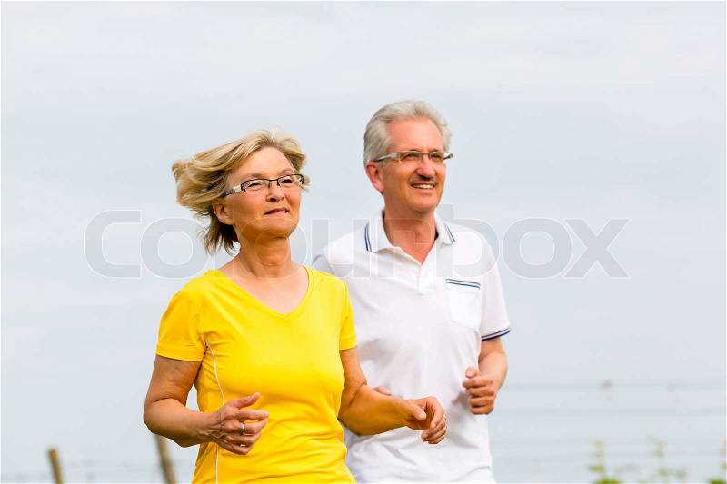 Seniors jogging in the nature doing sport, stock photo