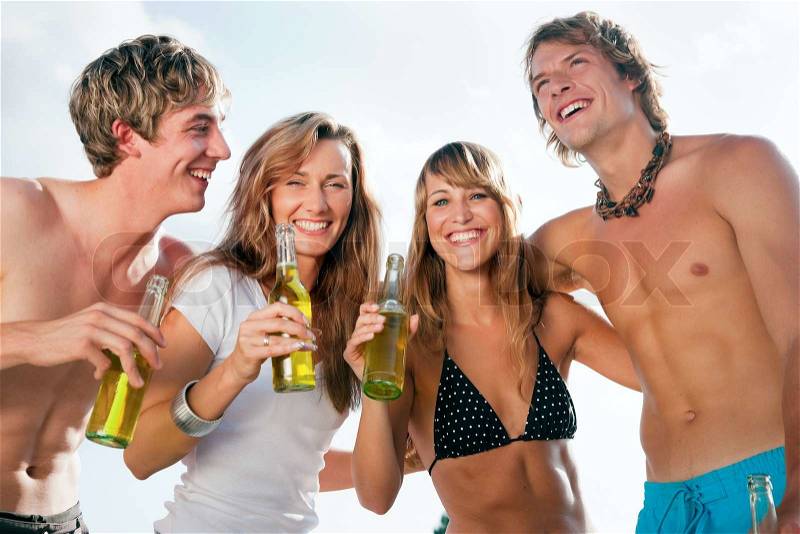 Group of four very beautiful people celebrating hot party on the beach in the summer of their lives - focus on faces, stock photo