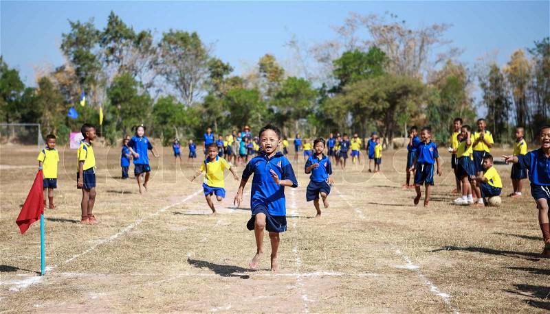 PHOCHAI,ROI-ET - JANUARY 10 : Unidentified Thai students 4 - 12 years old athletes in action during sport day on January 10, 2014 in Ban Donrue school, Phochai, Roi-Et, Thailand. , stock photo