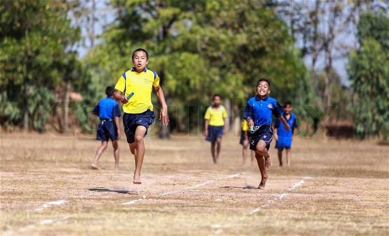 PHOCHAI,ROI-ET - JANUARY 10 : Unidentified Thai students 4 - 12 years old athletes in action during sport day on January 10, 2014 in Ban Donrue school, Phochai, Roi-Et, Thailand. , stock photo