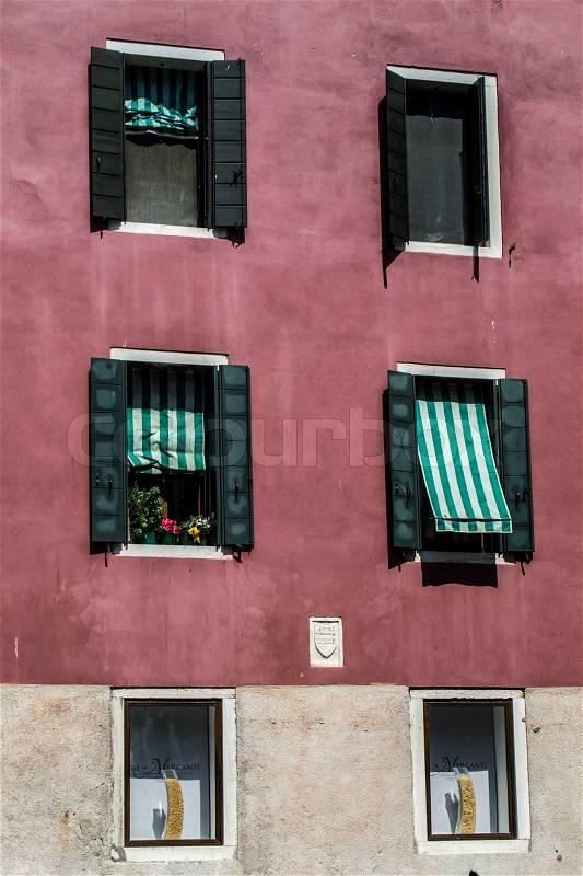Typical italian house with marguises on the windows, stock photo