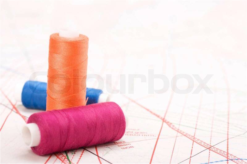 Spool of thread. Sew accessories on blurred background, stock photo