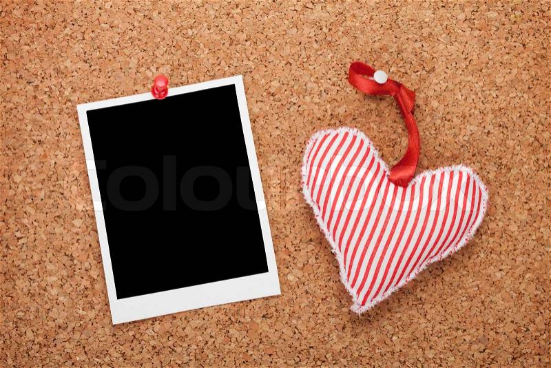 Blank instant photo and red heart. On cork wooden background, stock photo
