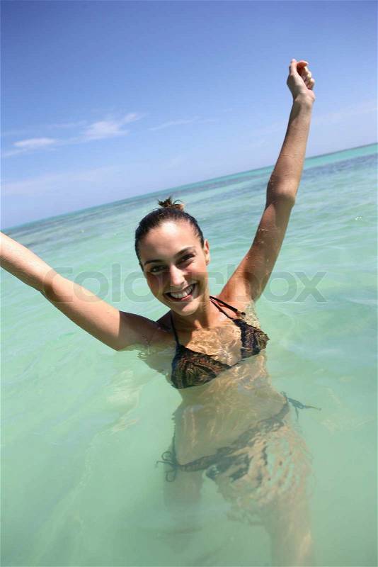 Happy woman bathing in the sea, stock photo