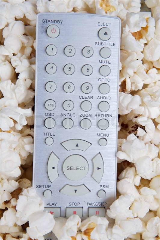 Popcorn and remote control prepared to see cinema, stock photo