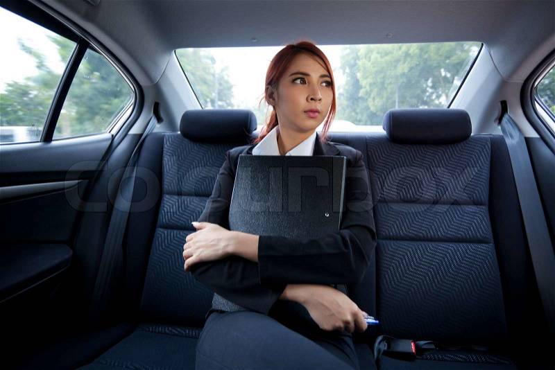 Beautiful young business asian with document in a car, stock photo