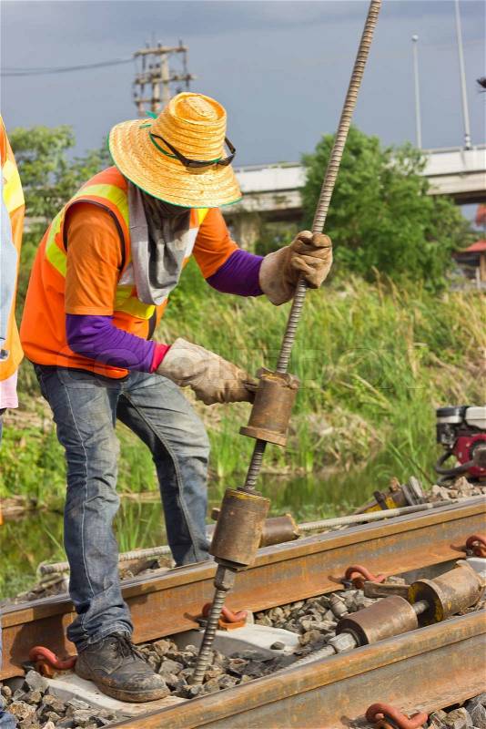 Workers preparing equipment for maintenance of the railway, stock photo